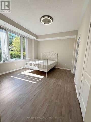 Aurora (Bayview Wellington) townhouse for rent - A bedroom with a white bed and wooden flooring.