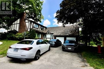 Aurora (Aurora Highlands) apartment for rent - A white car is parked in front of a house with a sign that says "REALTOR".