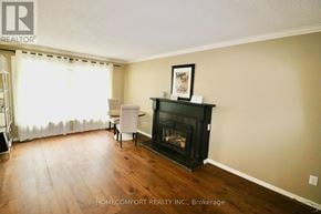 Aurora (Aurora Highlands) apartment for rent - A living room with a fireplace and a chair.
