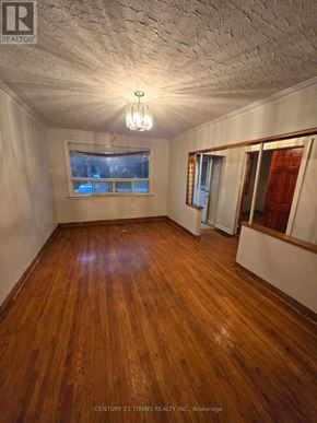 Mississauga (Mineola) apartment for rent - A room with wooden floors and a window with a view of a city.
