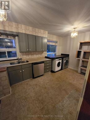 Mississauga (Mineola) apartment for rent - A kitchen with a sink, dishwasher, and a window.