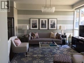 Toronto (Niagara) condo for rent - A living room with a grey couch, a white chair, and a coffee table.