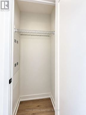 Toronto (Regent Park) condo for rent - A white closet with a shelf and a wooden floor.