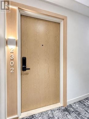 Toronto (Regent Park) condo for rent - A wooden door with the number 202 on it.