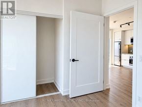 Toronto (Regent Park) condo for rent - A white door is open to a kitchen.