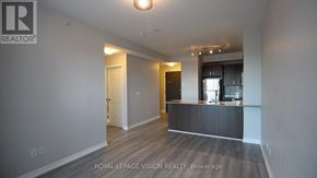Richmond Hill (Jefferson) condo for rent - A spacious room with a kitchen area in the background.