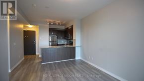 Richmond Hill (Jefferson) condo for rent - A spacious room with a kitchen area in the background.