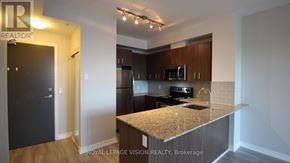 Richmond Hill (Jefferson) condo for rent - A kitchen with a granite countertop and stainless steel appliances.