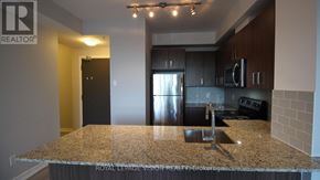 Richmond Hill (Jefferson) condo for rent - A kitchen with granite countertops and stainless steel appliances.