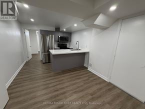 Markham (Greensborough) apartment for rent - A kitchen area with a sink and a microwave.