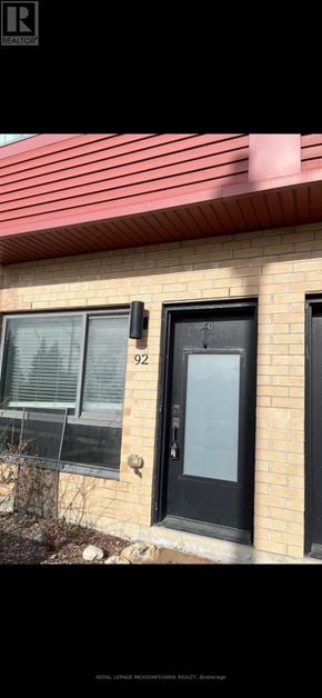 Barrie (Ardagh) townhouse for rent - A house numbered 92 with a black door and window.