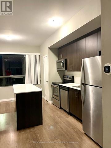Barrie (Ardagh) townhouse for rent - A modern kitchen with a refrigerator on the right.