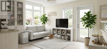 Brampton (Goreway Drive Corridor) townhouse for rent - A living room with a couch, television, and a plant.