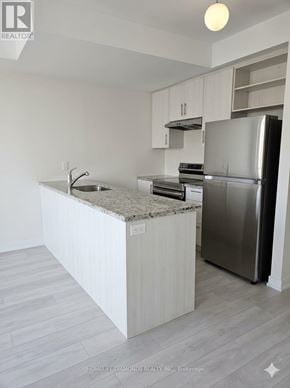 Brampton (Goreway Drive Corridor) townhouse for rent - A kitchen with a granite countertop and stainless steel appliances.