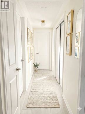 Brampton (Goreway Drive Corridor) townhouse for rent - A hallway with a rug on the floor and pictures on the wall.
