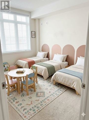Brampton (Goreway Drive Corridor) townhouse for rent - A bedroom with three beds and a round table.