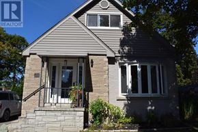Halton Hills (Ac Acton) apartment for rent - A house with a grey roof and a white car parked in front.