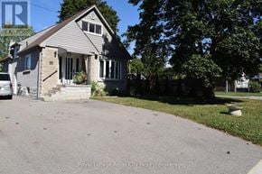 Halton Hills (Ac Acton) apartment for rent - A house with a grey roof and a white car parked in front.