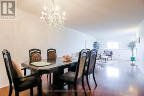 Toronto (L'amoreaux) condo for rent - A dining room with a table set for four and a chandelier hanging from the ceiling.