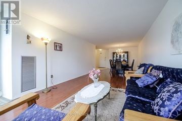 Toronto (L'amoreaux) condo for rent - A living room with a blue couch and a coffee table.
