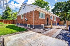 Burlington (Brant) apartment for rent - A red brick house with a black gate and a small front yard.