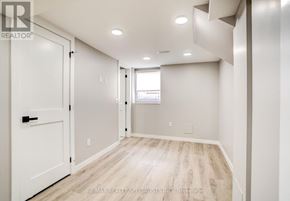 Burlington (Brant) apartment for rent - A white door is on the left of a room with a window.