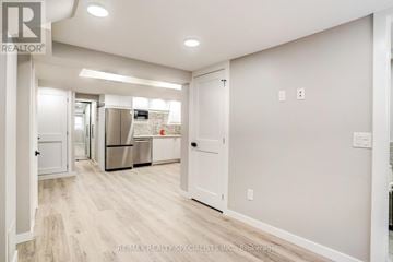 Burlington (Brant) apartment for rent - A spacious kitchen with white cabinets and a stainless steel refrigerator.