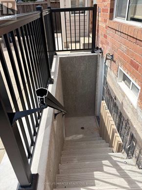 Brampton (Credit Valley) apartment for rent - A small concrete pool is surrounded by a black metal railing.