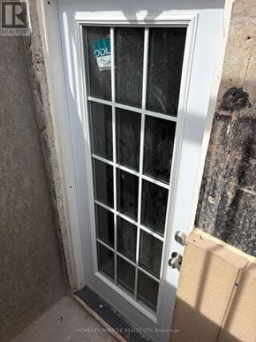 Brampton (Credit Valley) apartment for rent - A glass door with a handle and a cardboard box on the floor.