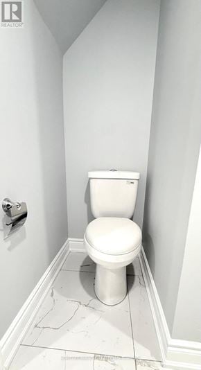 Brampton (Credit Valley) apartment for rent - A white toilet in a small bathroom with white walls.