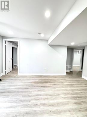 Brampton (Credit Valley) apartment for rent - A spacious room with a wooden floor and white walls.