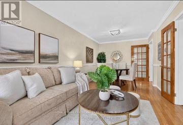 Pickering (Brock Ridge) apartment for rent - A living room with a couch, coffee table, and a dining table set up.