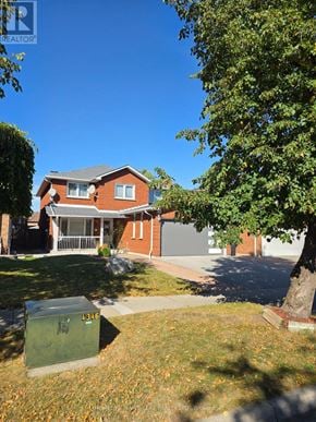 Brampton (Heart Lake West) apartment for rent - A house with a green trash bin in front of it.