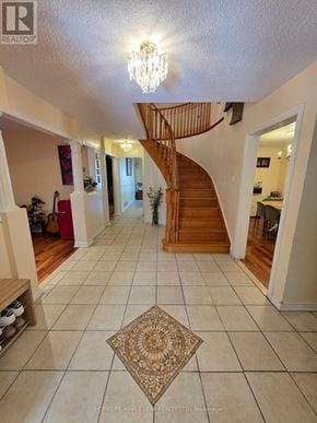 Brampton (Heart Lake West) apartment for rent - A spacious hallway with a staircase and a chandelier.