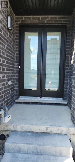 Welland (Lincoln/Crowland) townhouse for rent - A black door with a glass window is on a brick wall.