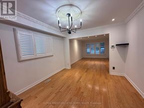 Markham (Raymerville) apartment for rent - A well-lit room with wooden floors and a chandelier.