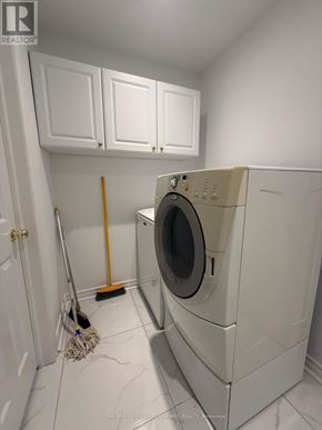 Markham (Raymerville) apartment for rent - A white washing machine in a laundry room.