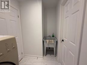 Markham (Raymerville) apartment for rent - A small bathroom with a washer and dryer.