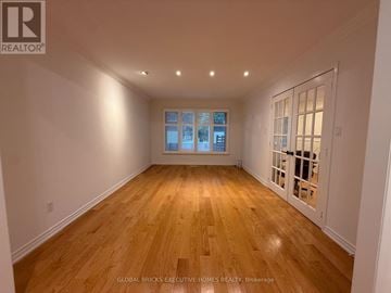 Markham (Raymerville) apartment for rent - A spacious room with wooden flooring and a large window.