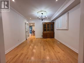 Markham (Raymerville) apartment for rent - A spacious room with wooden flooring and a chandelier hanging from the ceiling.