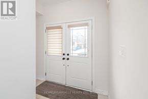 Thorold (Thorold Downtown) townhouse for rent - A white door with a glass window and a handle.