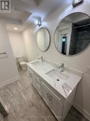 Whitby (Downtown Whitby) apartment for rent - A bathroom with a sink, mirror, and toilet.