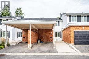 Waterloo townhouse for rent - A house with a covered driveway and a garage door.