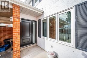 Waterloo townhouse for rent - A white house with a grey door and windows.