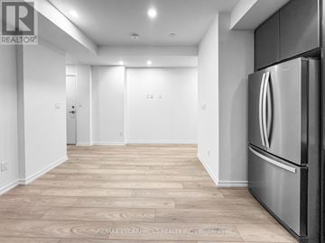 Newmarket (Glenway Estates) condo for rent - A kitchen with a stainless steel refrigerator and wooden flooring.
