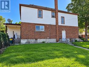 Niagara Falls (Hospital) apartment for rent - A house with a white siding and a brick chimney is for sale.