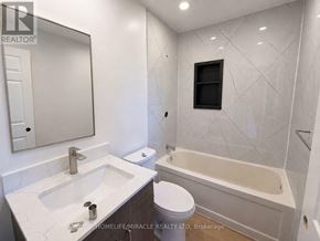 Niagara Falls (Hospital) apartment for rent - A bathroom with a white sink, toilet, and bathtub.