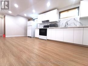 Toronto (Pleasant View) apartment for rent - A kitchen with white cabinets and a wooden floor.