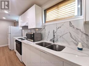 Toronto (Pleasant View) apartment for rent - A kitchen with a marble countertop and white cabinets.