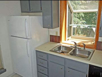 Boulder apartment for rent - A white refrigerator is in a kitchen with a window above the sink.